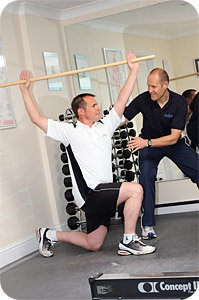 David Booth leading someone through an exercise designed to improve their golf swing